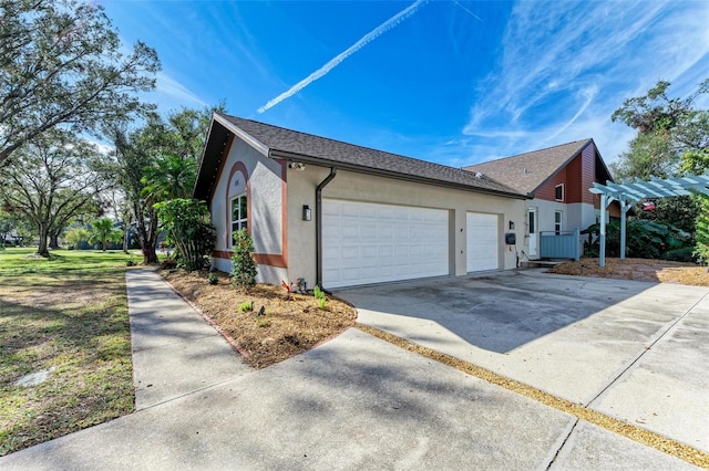 view of home's exterior with a garage and a pergola