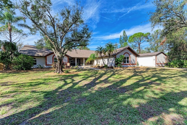 single story home with a garage and a front lawn