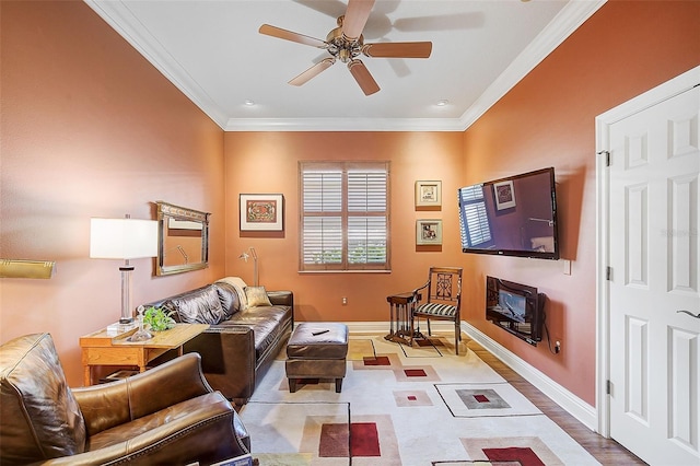 living room featuring light wood-type flooring, ceiling fan, and ornamental molding