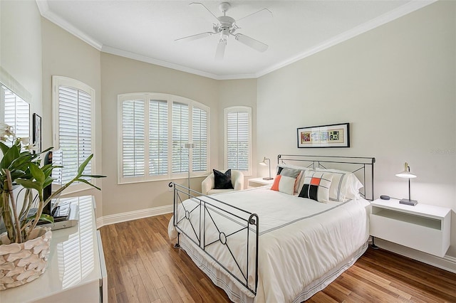 bedroom with ceiling fan, crown molding, and wood-type flooring