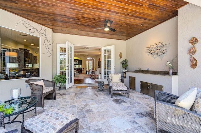 view of patio / terrace with french doors, ceiling fan, and exterior kitchen