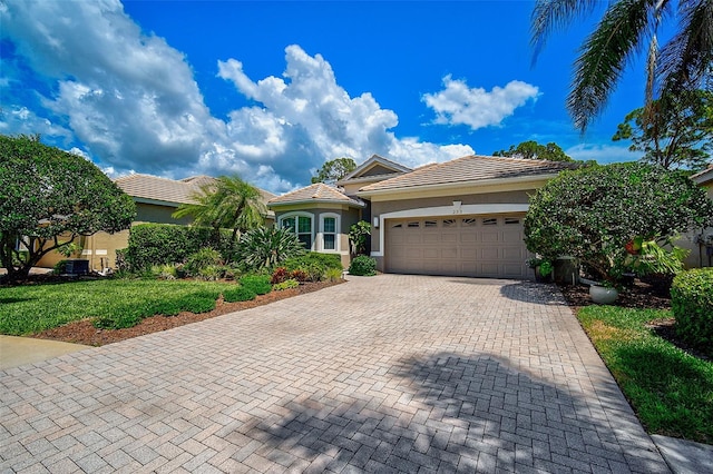 view of front of house with a garage and a front yard