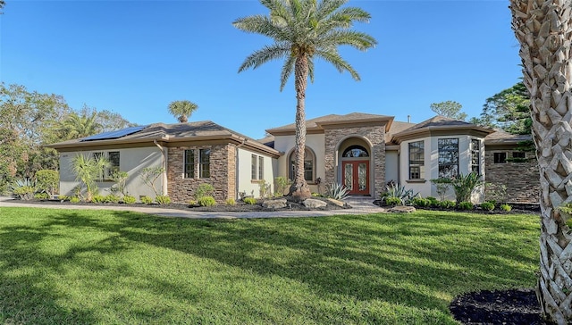 view of front of house with solar panels and a front yard