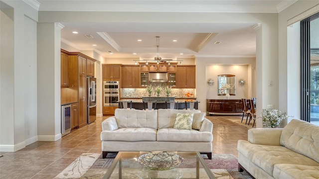 living room featuring light tile patterned flooring, a raised ceiling, crown molding, and beverage cooler