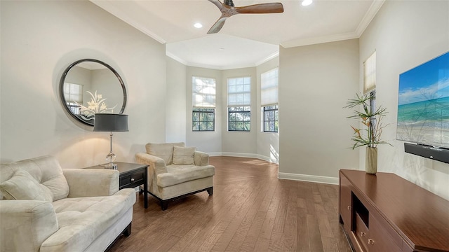 sitting room featuring hardwood / wood-style flooring, ceiling fan, and ornamental molding