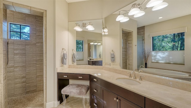 bathroom featuring tile patterned flooring, vanity, and shower with separate bathtub