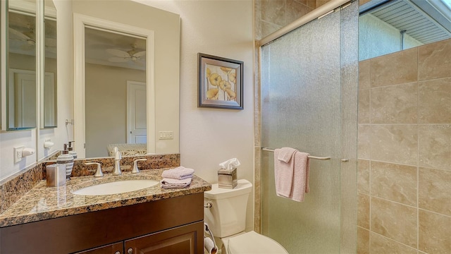 bathroom featuring ceiling fan, vanity, an enclosed shower, and toilet