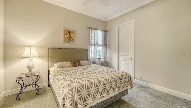 carpeted bedroom with ceiling fan and crown molding