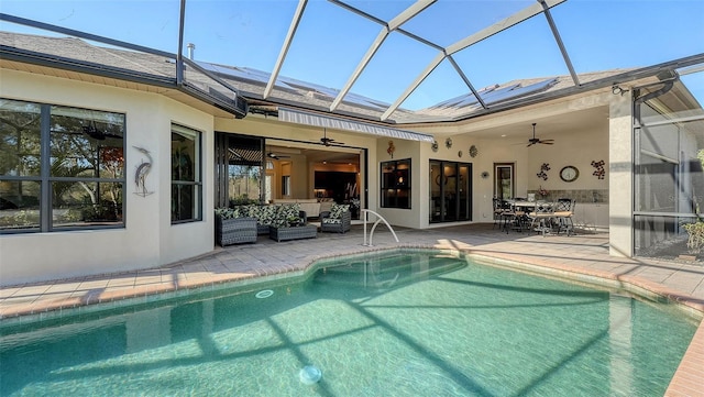 view of swimming pool featuring ceiling fan, a patio, and an outdoor living space