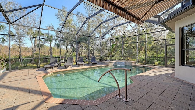 view of pool featuring glass enclosure and a patio area