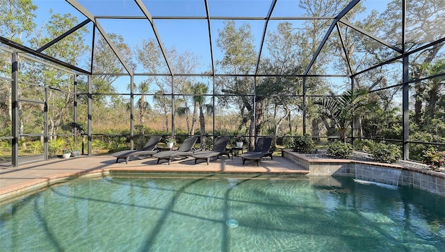 view of pool featuring pool water feature, a patio area, and a lanai