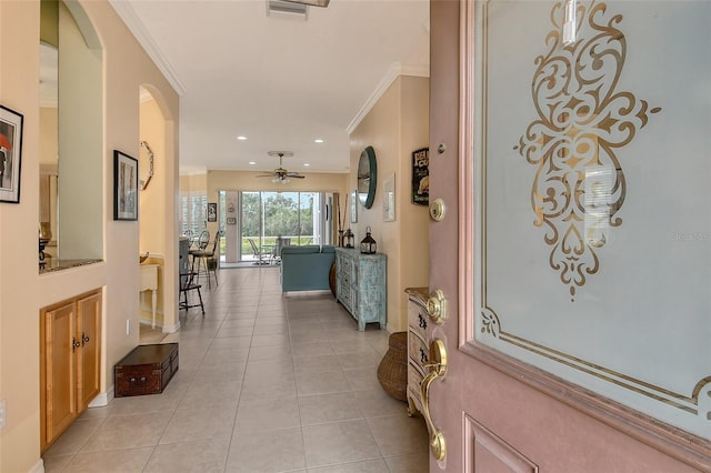 corridor with light tile patterned floors, visible vents, arched walkways, ornamental molding, and recessed lighting