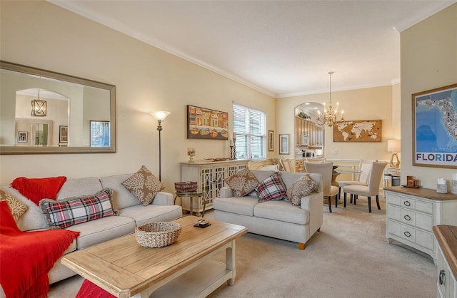 living room with a chandelier, crown molding, and light colored carpet