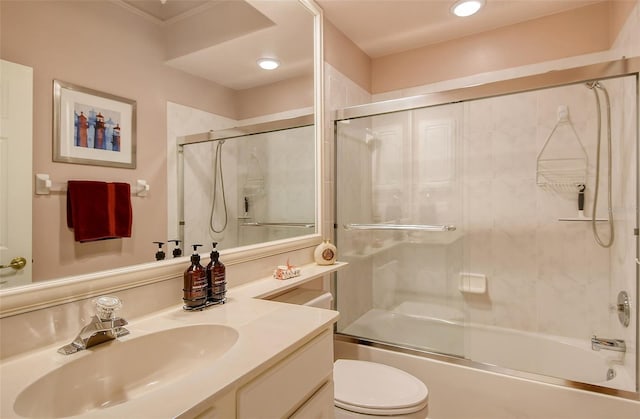 bathroom with toilet, recessed lighting, combined bath / shower with glass door, and vanity