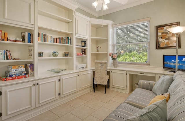 sitting room featuring crown molding, built in study area, ceiling fan, and light tile patterned flooring