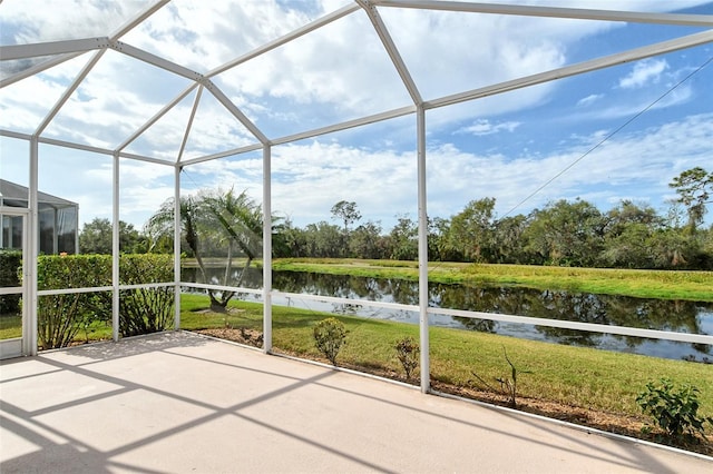 unfurnished sunroom featuring a water view