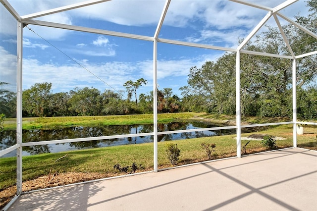 unfurnished sunroom featuring a water view