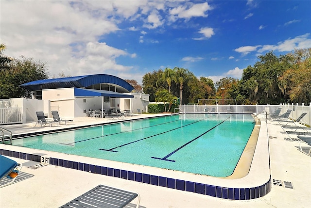 pool featuring a patio area and fence