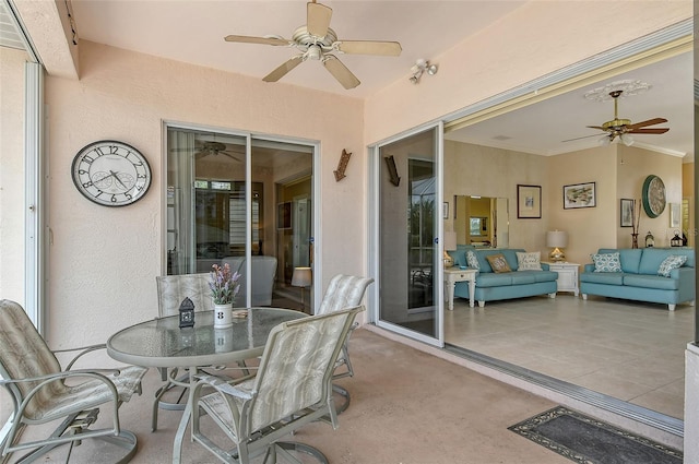 view of patio with an outdoor living space, a ceiling fan, and outdoor dining space