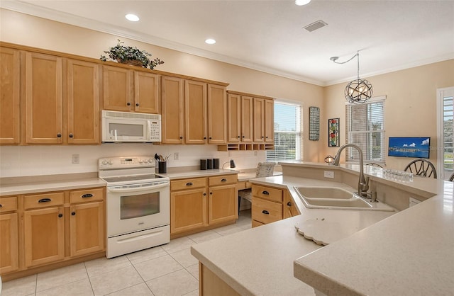 kitchen with light countertops, visible vents, hanging light fixtures, a sink, and white appliances