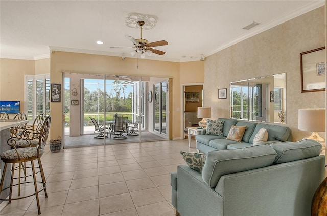 living area featuring light tile patterned floors, visible vents, a ceiling fan, a sunroom, and ornamental molding