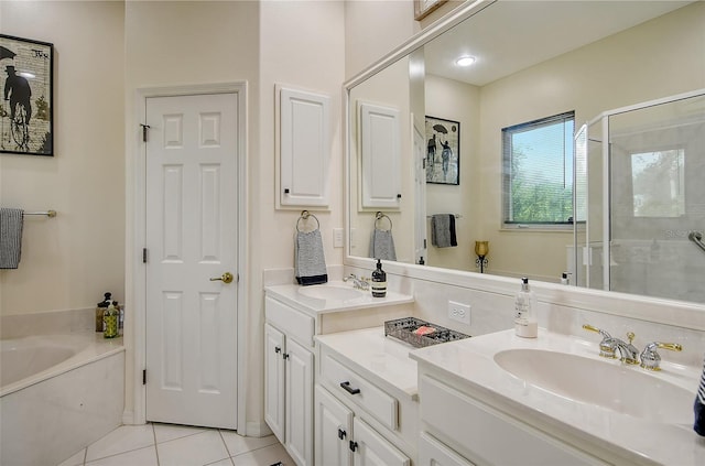 bathroom featuring a stall shower, a garden tub, a sink, and tile patterned floors