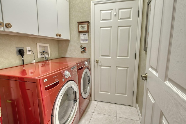 washroom featuring light tile patterned floors, cabinet space, and washer and dryer