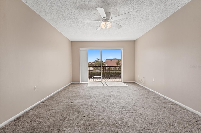 spare room featuring a textured ceiling, light colored carpet, and ceiling fan