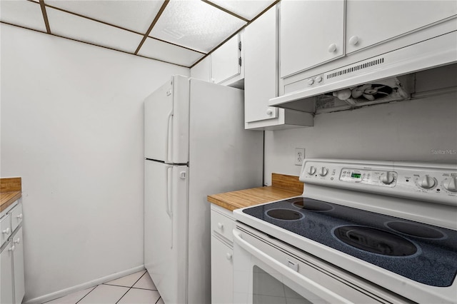 kitchen featuring white cabinets, white appliances, and light tile patterned floors