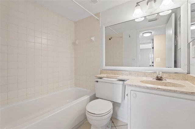 full bathroom featuring tile patterned floors, vanity, tiled shower / bath combo, and toilet