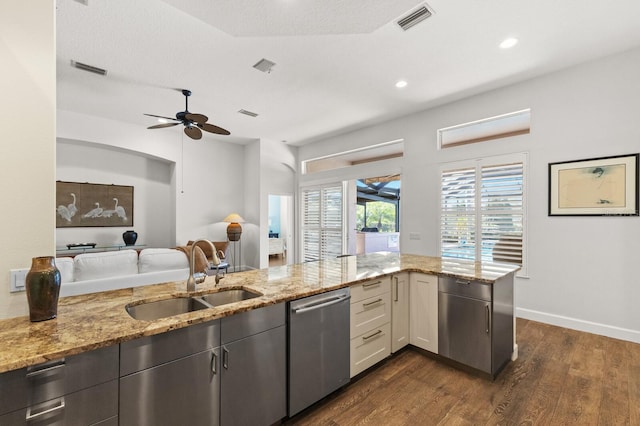 kitchen featuring dishwasher, sink, dark hardwood / wood-style floors, ceiling fan, and light stone countertops