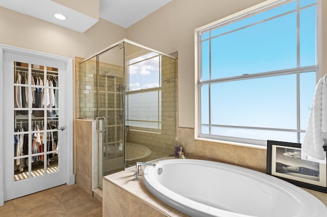 bathroom with tile patterned flooring and plus walk in shower