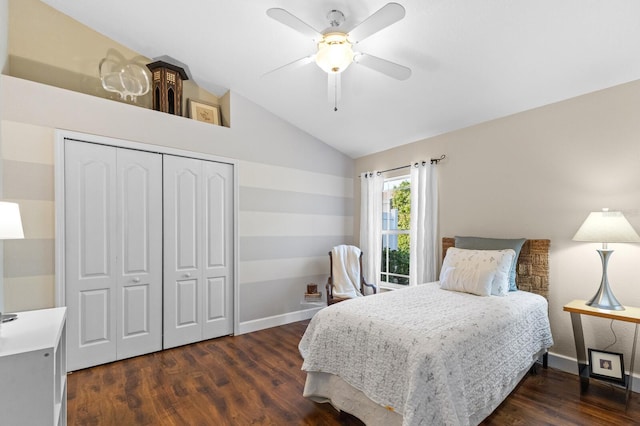 bedroom with ceiling fan, vaulted ceiling, dark hardwood / wood-style floors, and a closet