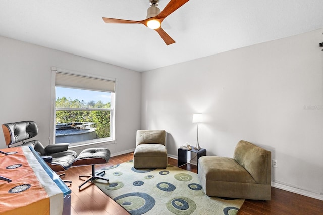 sitting room with ceiling fan and hardwood / wood-style flooring