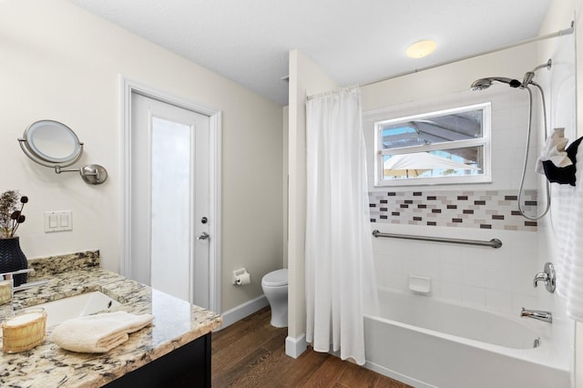 full bathroom with shower / bathtub combination with curtain, hardwood / wood-style floors, vanity, and toilet