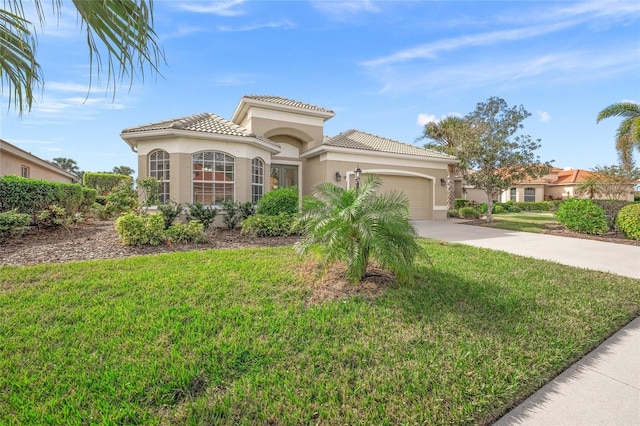 mediterranean / spanish house featuring a front yard and a garage