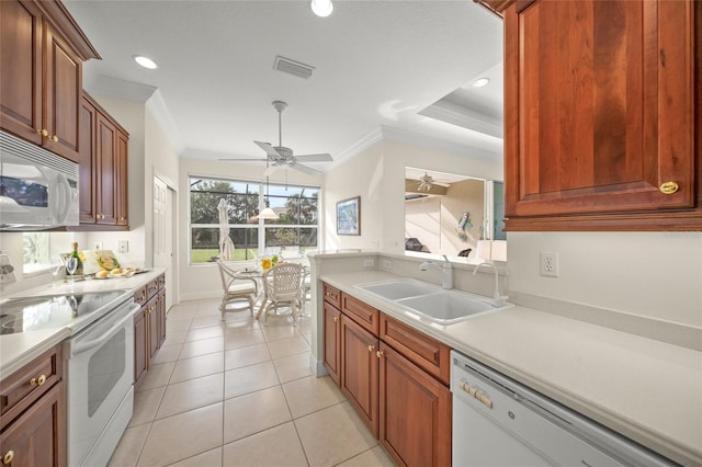 kitchen with light tile patterned floors, white appliances, ornamental molding, and sink