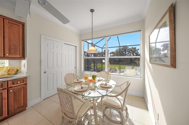 dining space featuring ceiling fan, light tile patterned floors, and crown molding