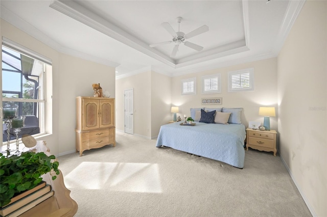 bedroom featuring light carpet, a raised ceiling, ceiling fan, and crown molding