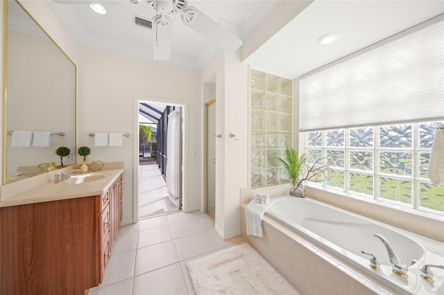 bathroom featuring ceiling fan, plus walk in shower, tile patterned floors, vanity, and ornamental molding