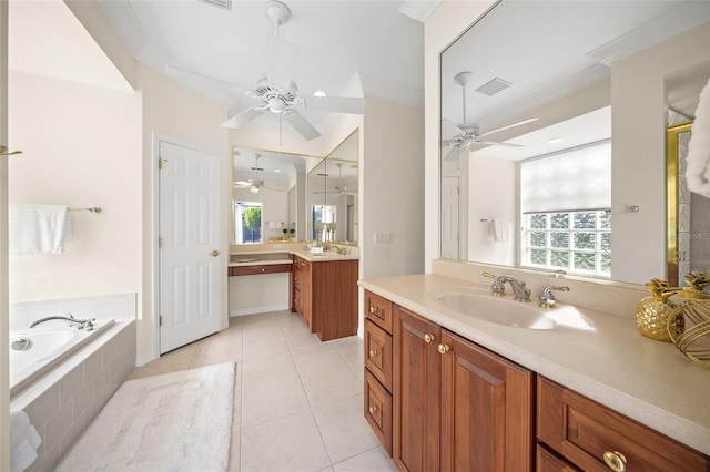 bathroom featuring tile patterned flooring, vanity, and tiled bath