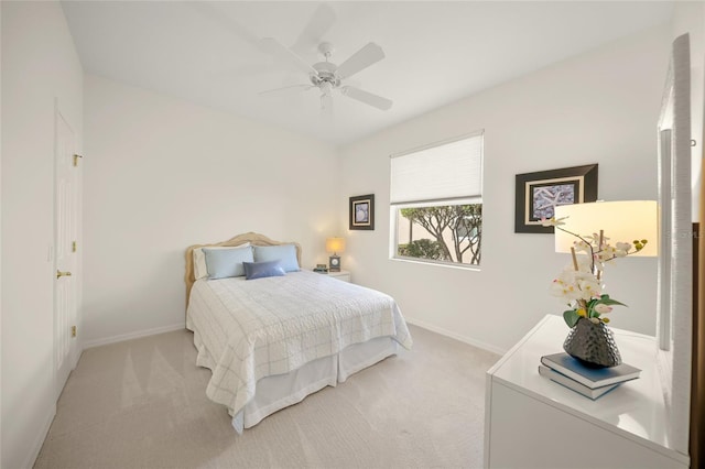 bedroom with ceiling fan and light colored carpet