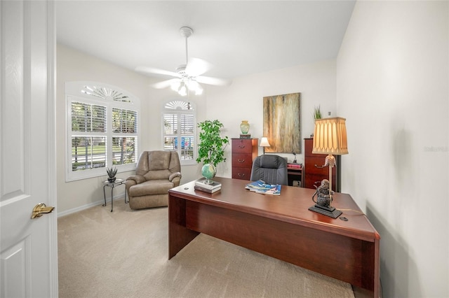 home office featuring light carpet and ceiling fan