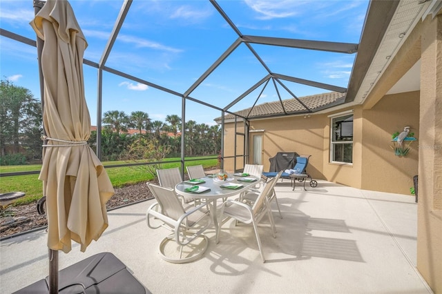 view of patio featuring a lanai