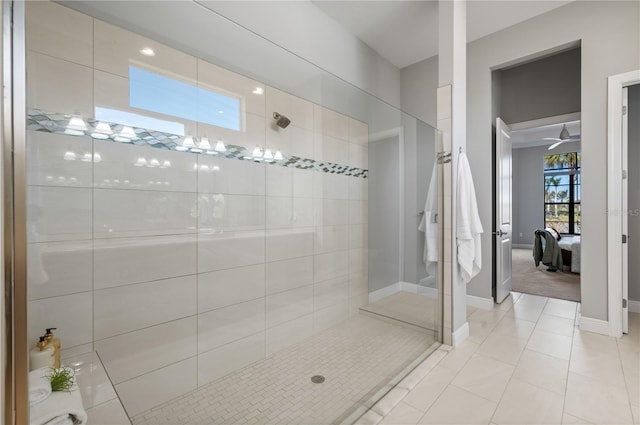 bathroom with tile patterned floors, ceiling fan, and tiled shower