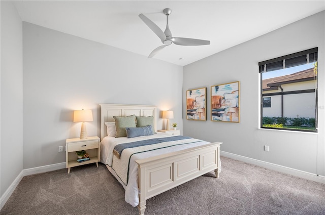 bedroom featuring ceiling fan and dark carpet