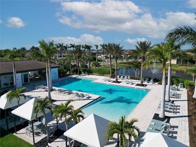 view of pool featuring a water view and a patio area