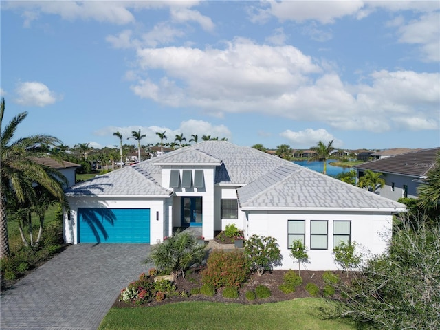 view of front facade featuring a garage and a water view