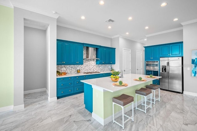 kitchen with a kitchen bar, wall chimney range hood, stainless steel appliances, decorative backsplash, and a center island with sink