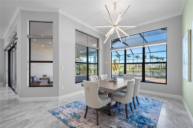 dining room featuring crown molding, a water view, and a notable chandelier